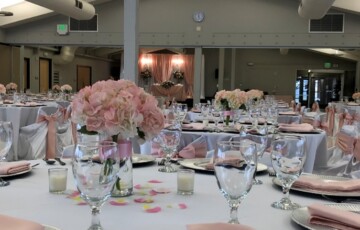 tables set with pink flowers in a wedding setting