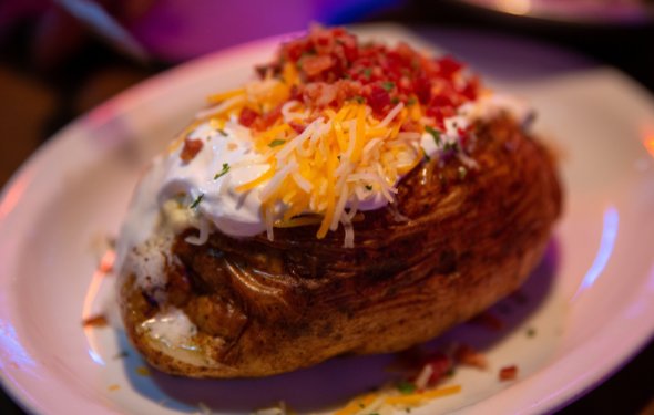 baked potato with sour cream, cheese and bacon crumbles