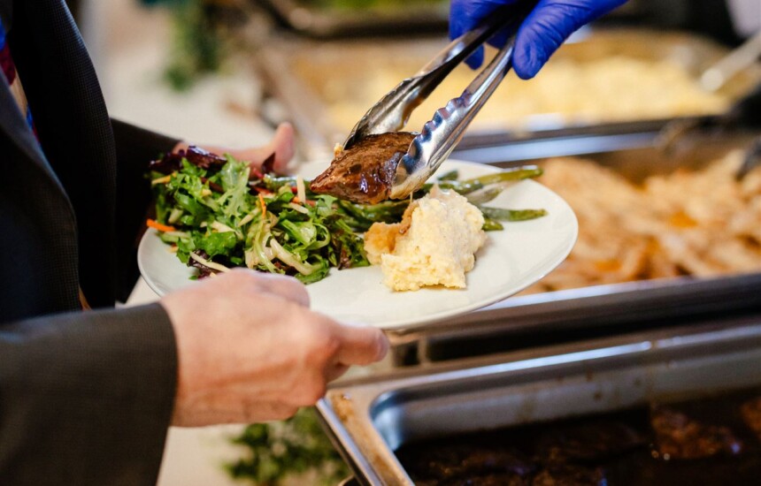 Server placing food on guest plate