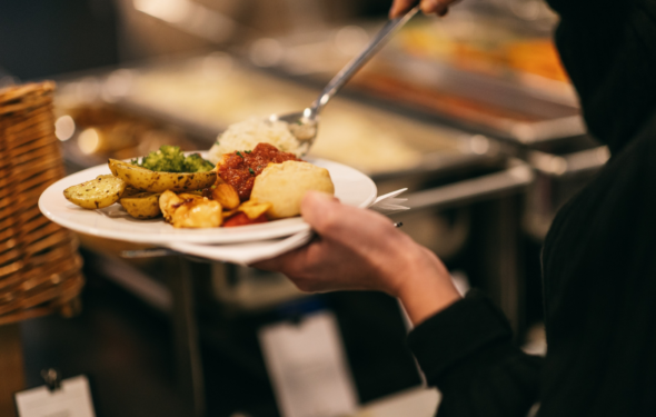 serving hot food items from a buffet on to plate